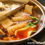 Vegan Chinese hot pot simmering in a spicy mala soup base.