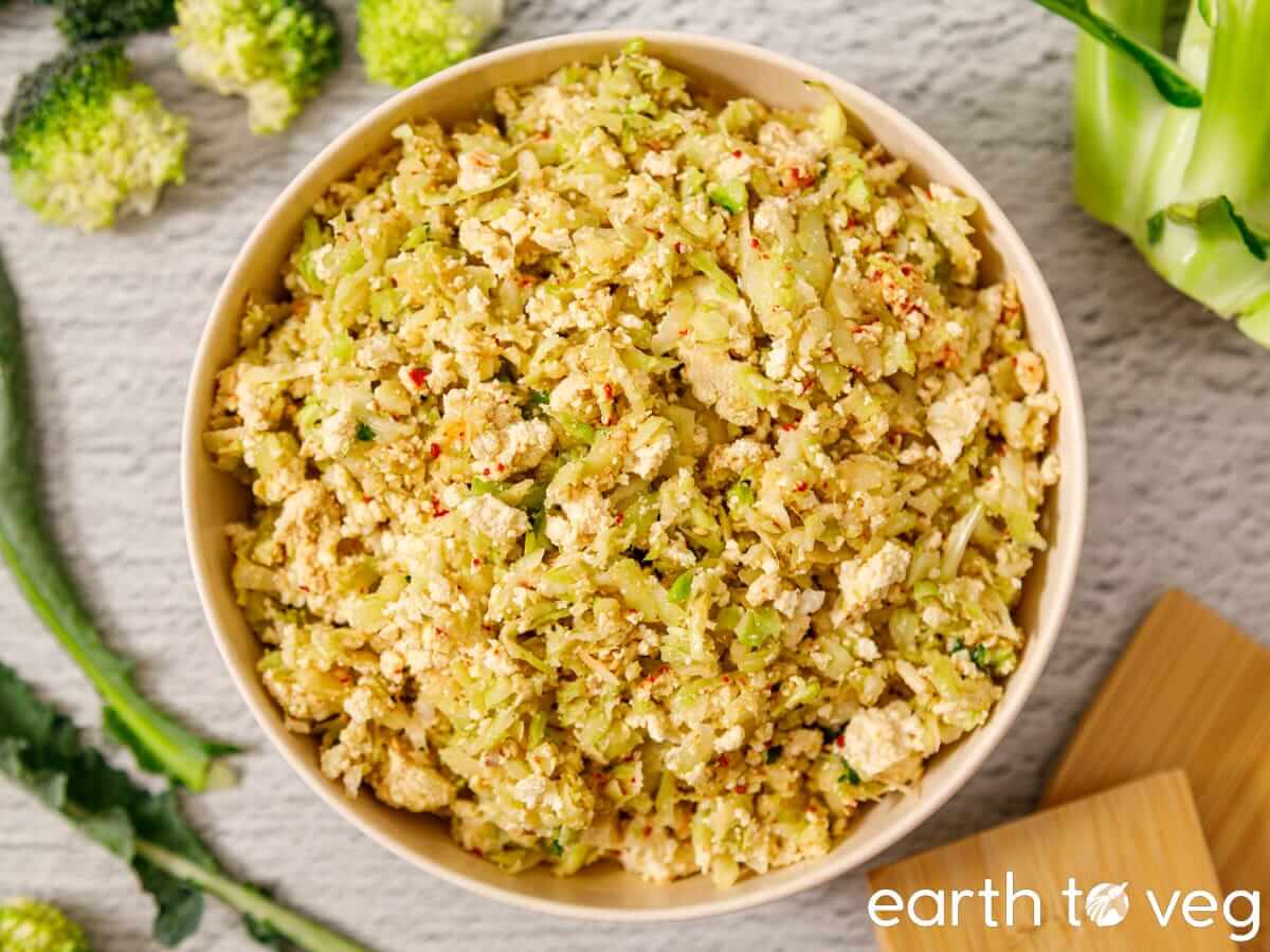 Broccoli stalk salad with crumbled tofu, sesame seeds, and red pepper flakes.